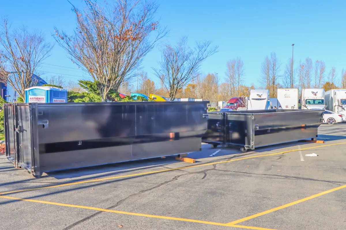 Professional dumpster rental service with roll-off container on residential driveway in Onalaska